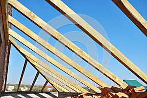 Roofing wooden frame house construction with roof beams, trusses, timber, braces and eaves