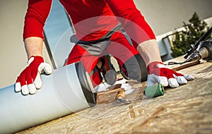 Roofing Worker with Roll of EPDM Rubber Material