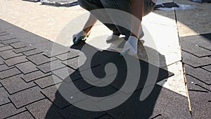 Roofing works. Laying of a soft tile element on the slab. Installation of the roof to the base.