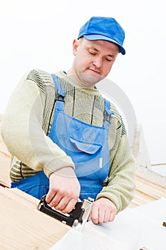 Roofing works with staple gun