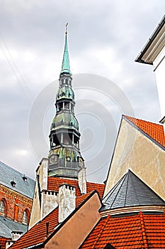 Roofs of buildings in old town and top view of church of St. Peter St. Peter`s Church, Petrikirche, Riga photo