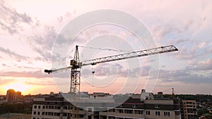 Roofs of high-rise buildings, tops of cranes on construction project of new residential areas, urban landscape with