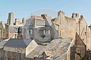 Roofs and houses of Saint Malo in summer with blue sky.