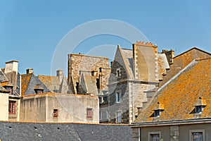 Roofs and houses of Saint Malo in summer with blue sky. Brittany.