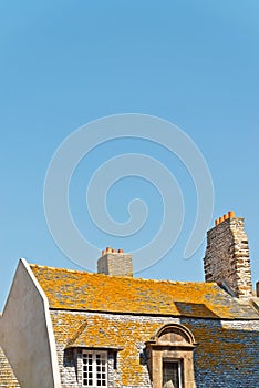 Roofs and houses of Saint Malo in summer with blue sky. Brittany.