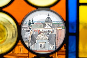 The roofs of Krakow`s Old Town through the colored stained glass from the Town Hall Tower on a summer day