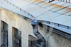 roofs of old brick houses, covered with galvanized sheets and rainwater downpipe. Saint-Petersburg, Russia