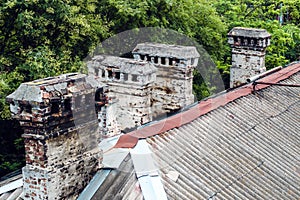 roofs of old houses with chimneys made of antique stone.