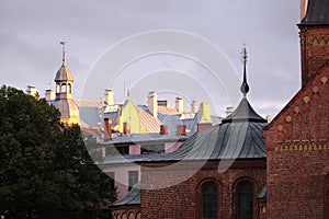 Roofs and spires of old town Riga buildings on the sunset