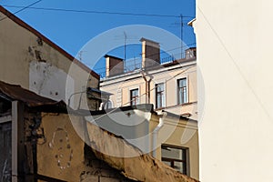 Roofs and walls of urban residential buildings. view of the old facades below. Saint-Petersburg, Russia