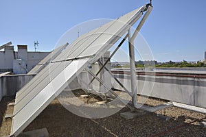 Rooftop of a building with solar panels and hot water tank photo