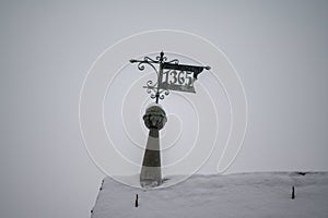 Rooftop ironwork date sign and weathervane inscribed with 1365