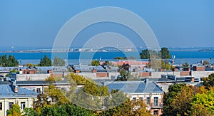 Rooftop Kronstadt view from belltower of Naval Cathedral of Saint Nicholas in golden autumn day with dam on background