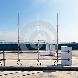 Rooftop small radio communication tower antenna and television. Is device that converts electricity into electromagnetic waves.