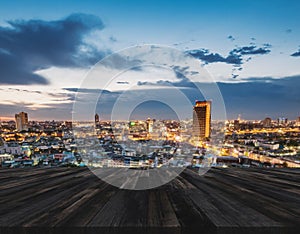 Rooftop wood floor, with cityscape view of Bangkok city in evening