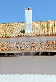 Rooftops and chimney of a typical Andalusian cortijo farmhouse located in the fertile farmlands near the city of Seville