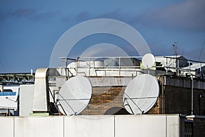 Rooftops of the city with smoke outlets, ducted air conditioning machines and satellite dishes