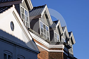Rooftops with dormer windows sky blue