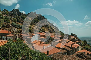 Rooftops of old houses on hilly landscape in Monsanto