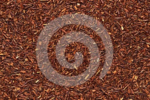 Rooibos tea texture closeup. Dry redbush healthy tea, top view