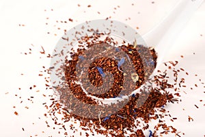 Rooibos tea on white background. Top view. Close up.