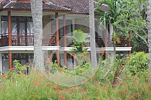 a room area in a hotel with a terrace overlooking the garden