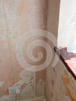 A room being decorated showing bare walls and patchy plaster