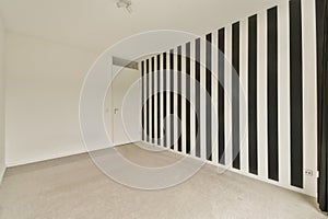 a room with black and white stripes on the wall