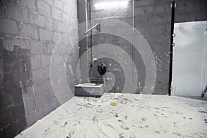 A room with brick walls and white powder, whitewash, or flour on the floor. Photo studio for photography with flour