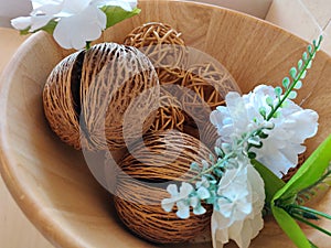 The room decoration by suiside tree seeds with artifact flowers in wooden bowl