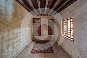 Room at El Sehemy house, a historic old house with embedded wooden cupboard, wooden window and colorful carpet, Cairo, Egypt photo