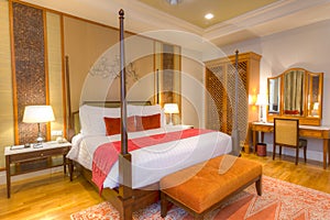 Room with four poster bed and other furniture