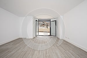 Room with freshly painted white walls with ceramic floors, front door