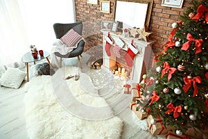 Room interior with Christmas tree and gifts near decorative fireplace