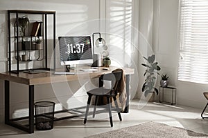 Room interior with comfortable workplace. Modern computer on wooden desk