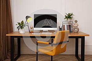 Room interior with comfortable workplace. Modern computer on wooden desk