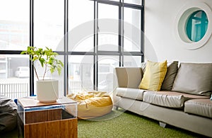 Room, interior and furniture with an empty space in a modern home or office during summer. Business, home and sofa in a
