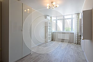 Room interior with wardrobe and hanging cupboards