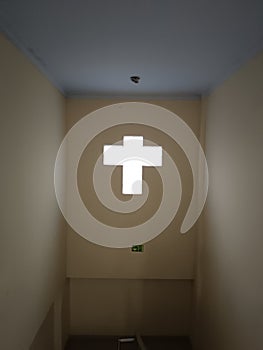 Room lighting that resembles a cross symbol.