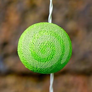 Room ornamented with a green color silk cover light bulb.