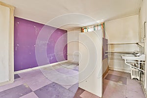 a room with purple and white walls and a sink