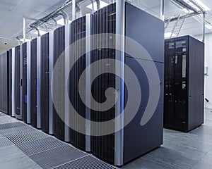 Room with rows of server hardware in the data center