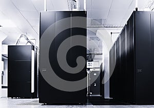 Room with rows of server hardware in data center