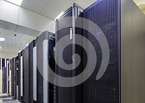 Room with rows of server hardware in data center