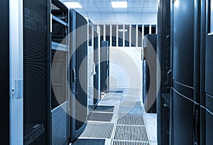 Room with rows of server hardware in the data center