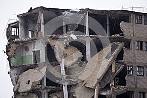 Room sections in the half-destroyed building. The collapse of the wall.