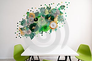 Room, table and chairs. Green, emerald, gold and yellow papers circle shape of origami. Abstract background of paper