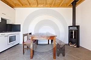 Room with table and wood stove