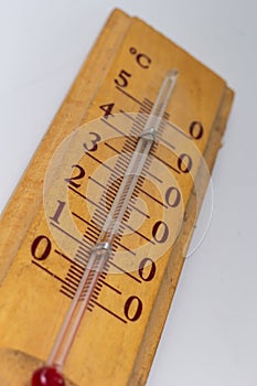 room thermometer on a wooden base close up on a white background. Celsius degree scale