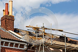 a room without tiles on while roofers prepare to fix new tiles